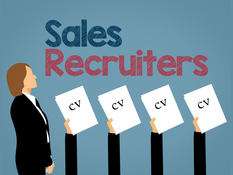 sales recruiters considering applicant CVs in hands