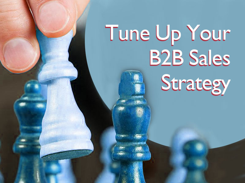 hand moving a chess piece to illustrate tuning up your B2B sales strategy